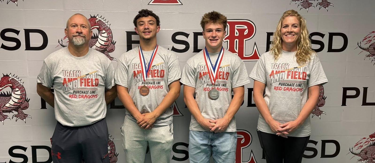 Two track coaches adn two boys who qualified for the State Track Meet.