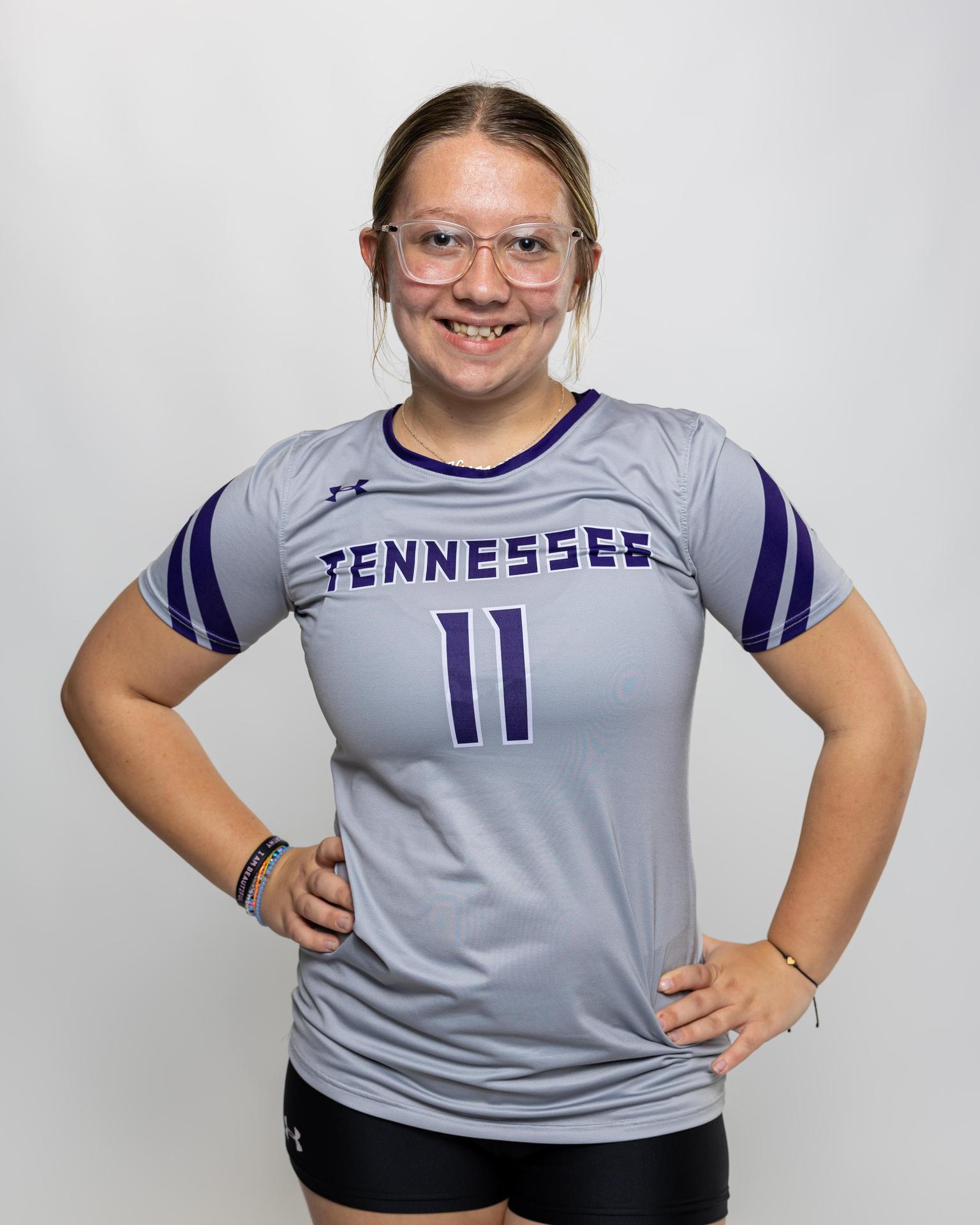 number 11 female volleyball player posing