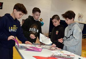 four boys putting together a puzzle
