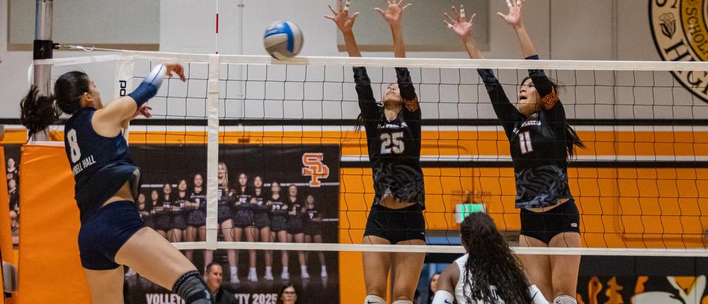 girls playing volleyball in the gym