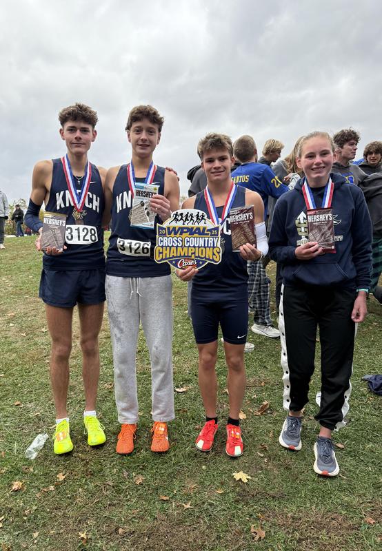 pic of 4 runners, wearing medals