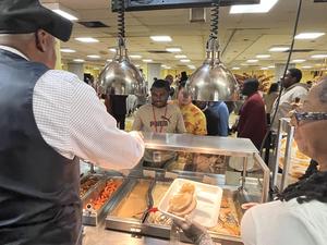 Mr. McCaskill serves Friendsgiving lunch to a student