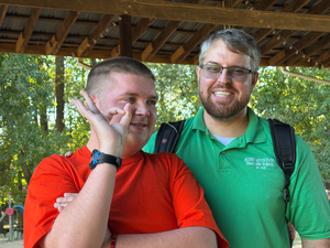 student and teacher photographed from shoulder up smiling for camera