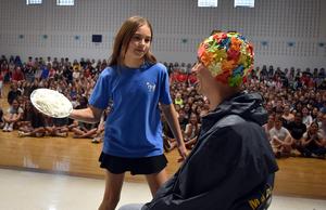 a student throwing a pie in a teacher's face