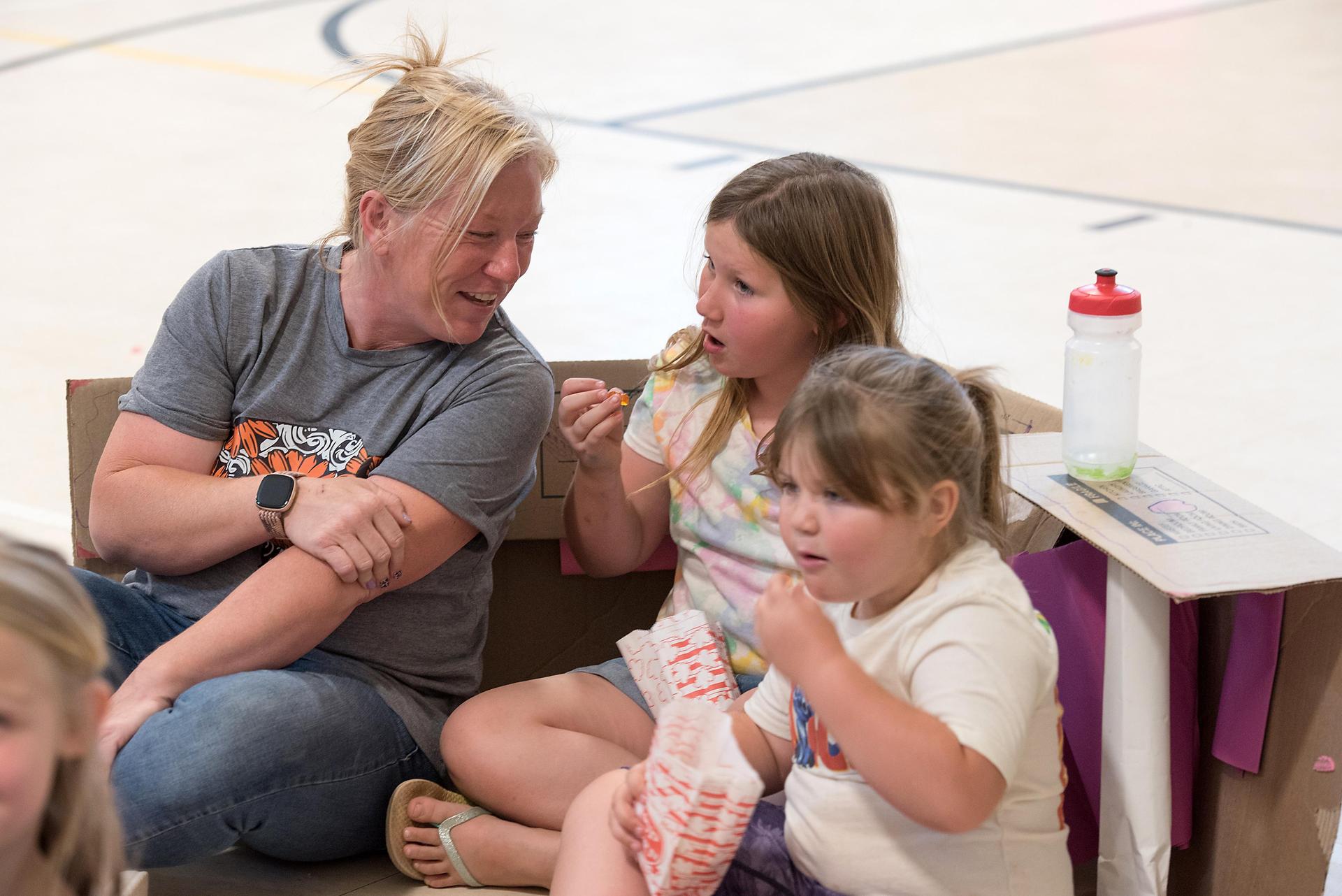 students watching a movie in cardboard cars