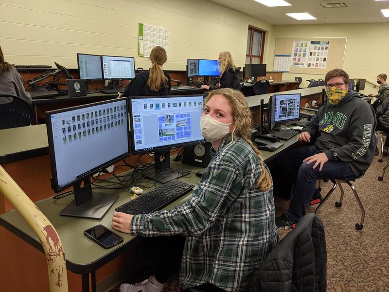 Students work on yearbook page layouts