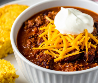 Bowl of chili topped with cheese and sour cream