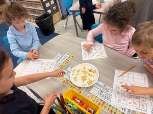Students counting pumpkin seeds.