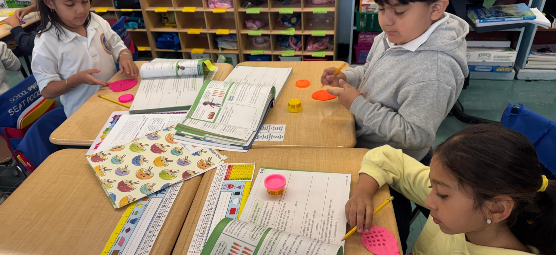 students using play doh to learn about addition facts