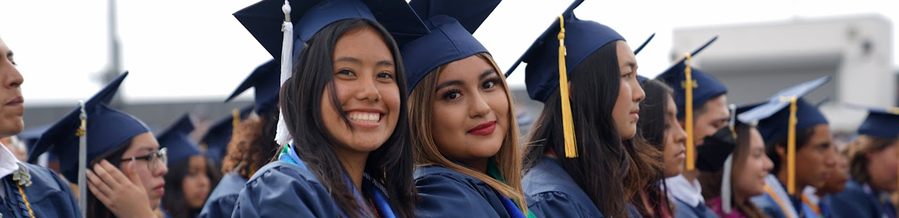 high school graduates in caps and gowns