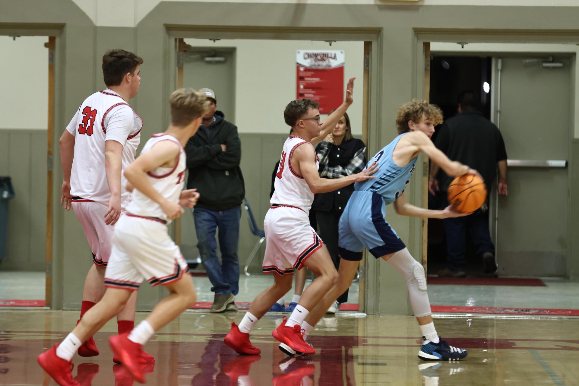 Varsity boys playing basketball against yosemite