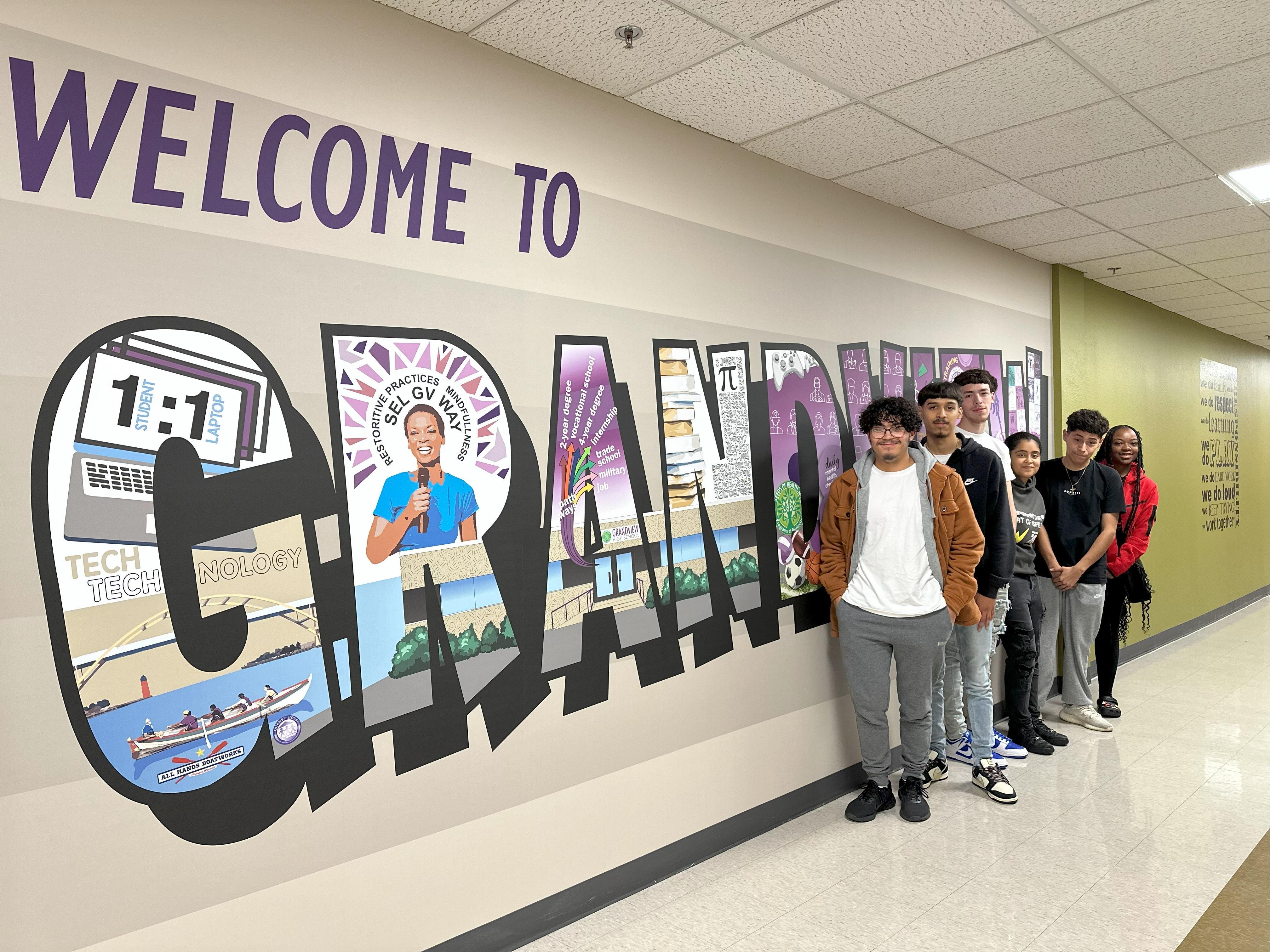 Grandview students standing in front of a mural reading 'Welcome to Grandview'