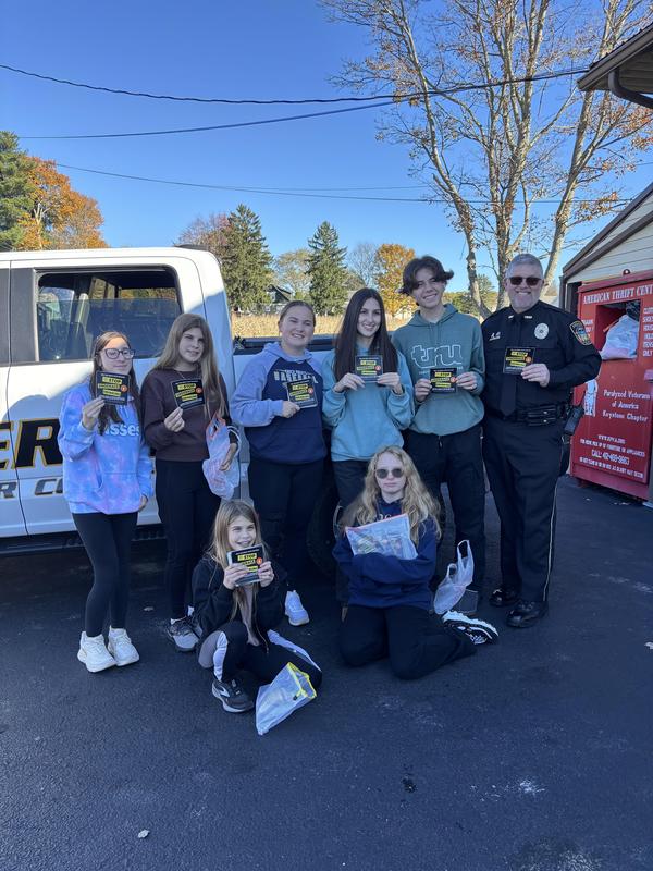 students posing in front of a truck