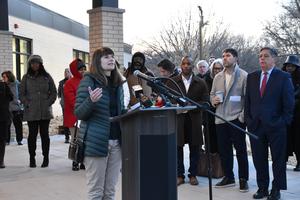 mayor comans Speaking at podium