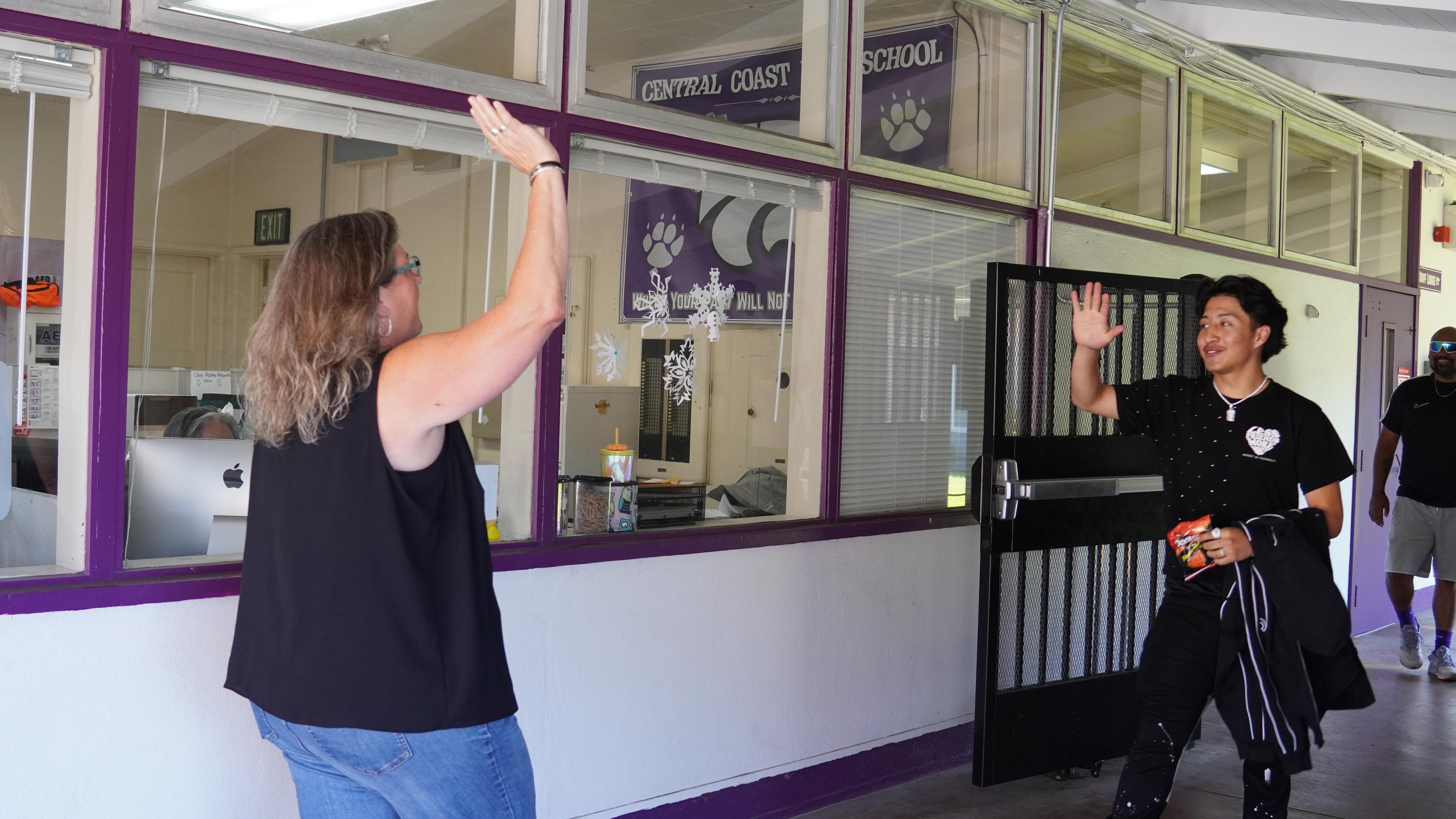 Principal giving high five with student