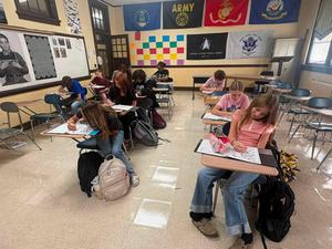 Coach Chrestman's class hard at work on the playbook