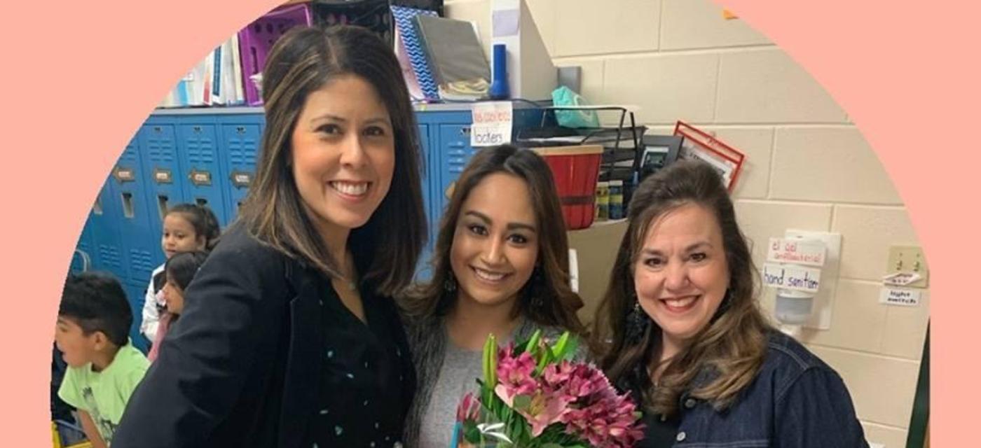 Admin and teacher posing for support staff of the year.