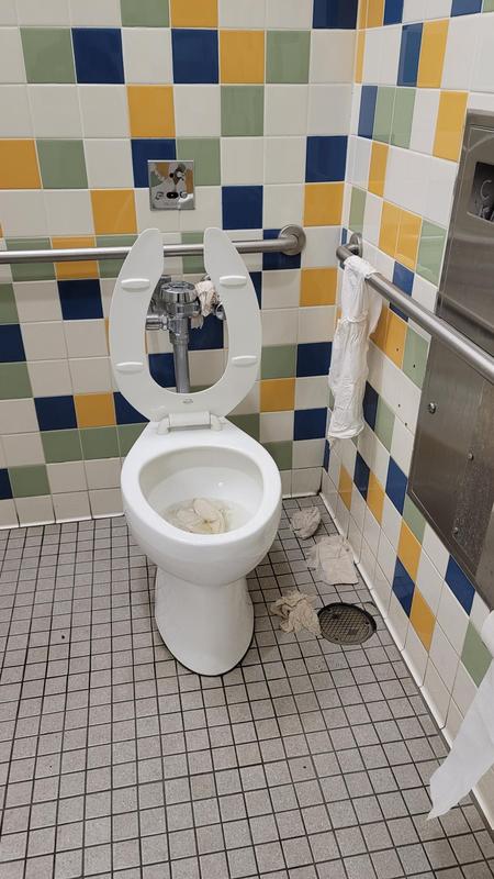 Bathroom with trash everywhere.