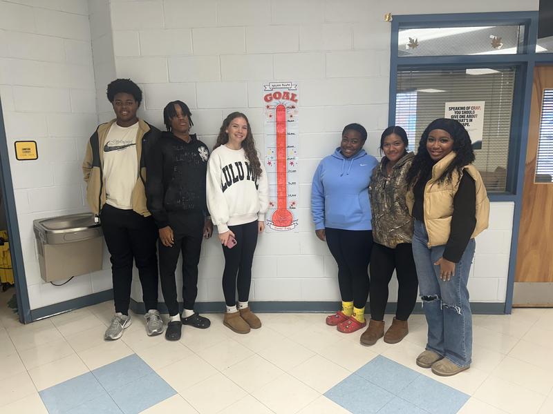 Students showing off their glow in the dark bracelets