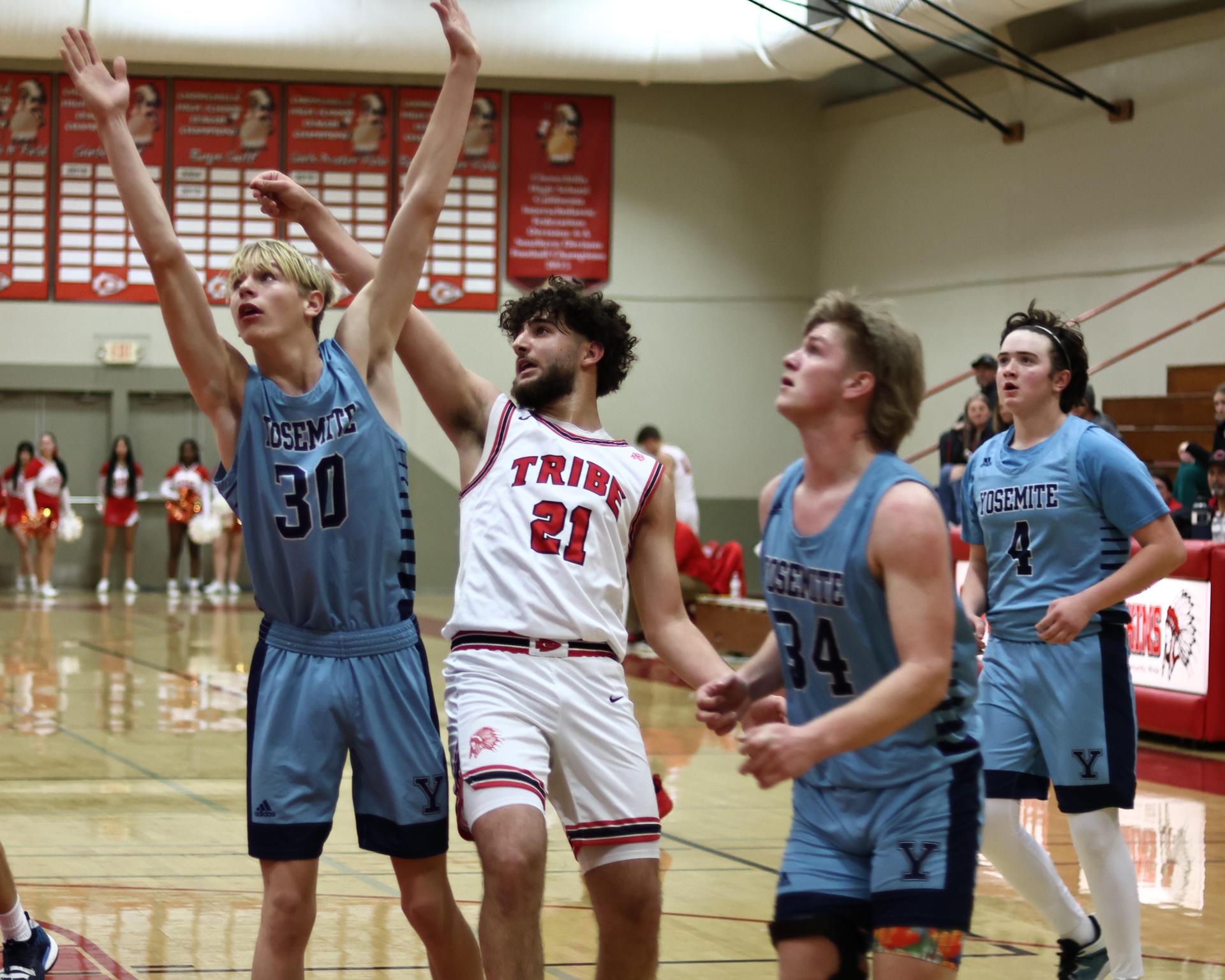 Varsity boys playing basketball against yosemite