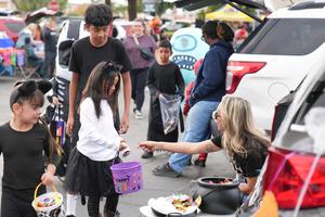 students get candy during Trunk or Treat