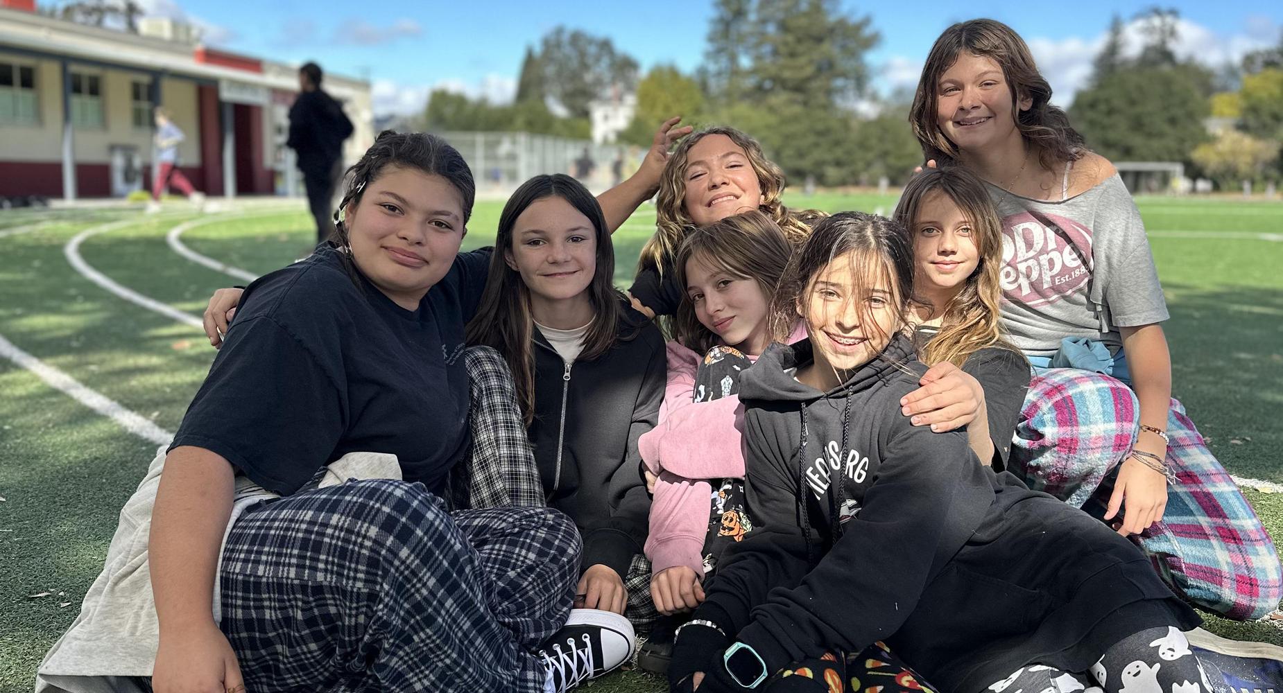 A group of students posing together on the field