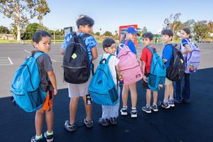 Magnolia Students Displaying their New Backpacks.