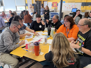 Teachers working together around a table during professional development