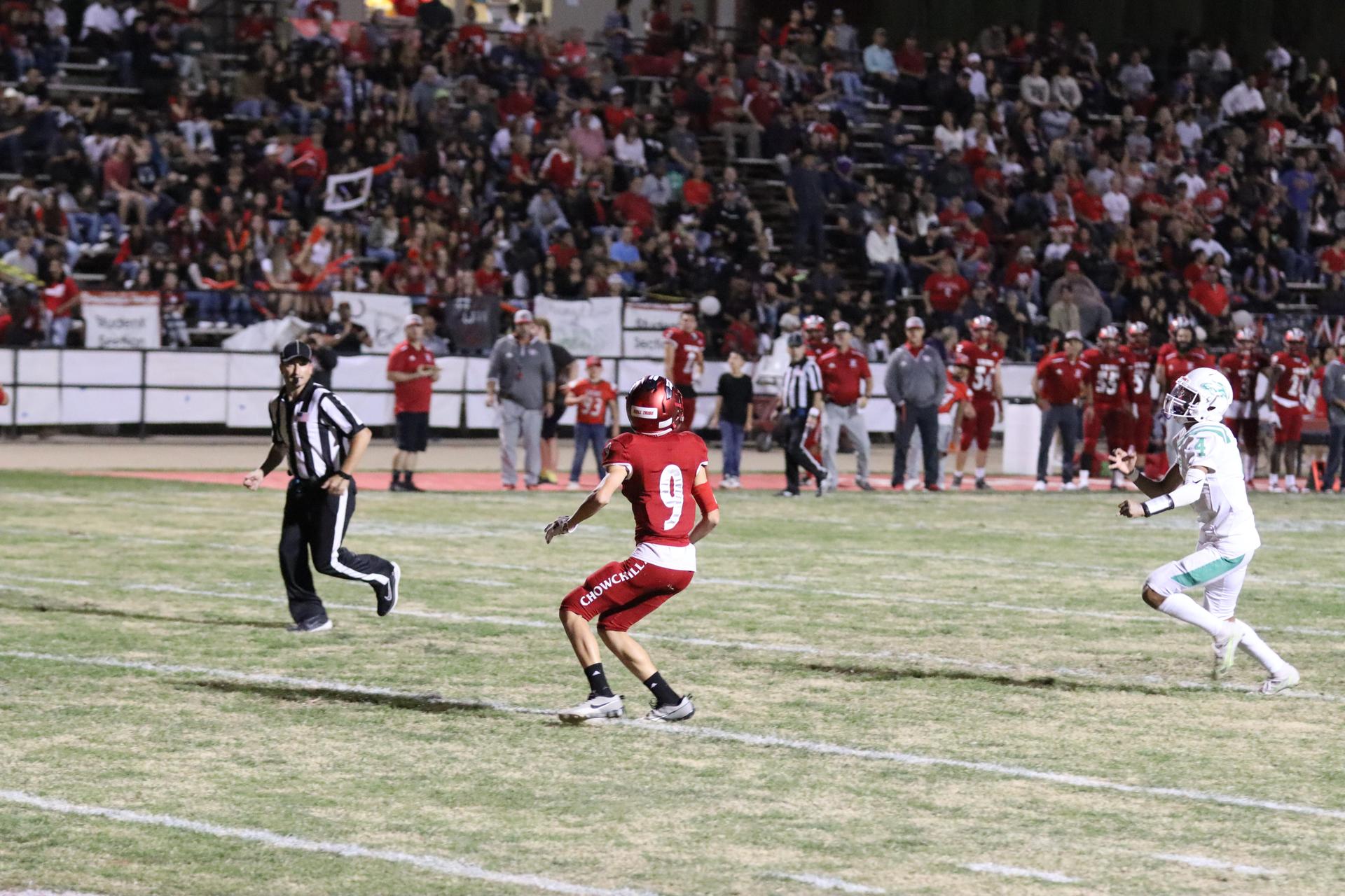 varsity football players in action against Riverdale