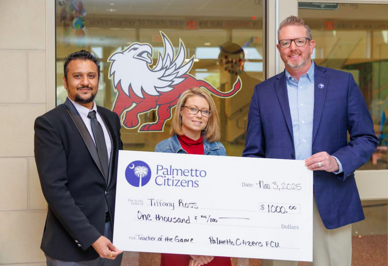 Tiffany Ross, center, with a big check for $1,000 from Palmetto Citizens representatives, standing on both sides of her