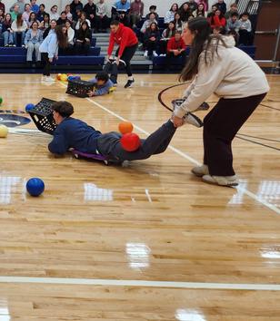 group of students playing interactive games like human hungry hungry hippos