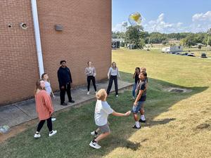 The group prepares to kick the ball up the hill