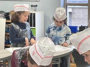 two girls working together at the math bakery.