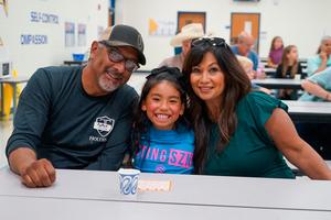 Grandparents with student playing Bingo at Grandparents Day