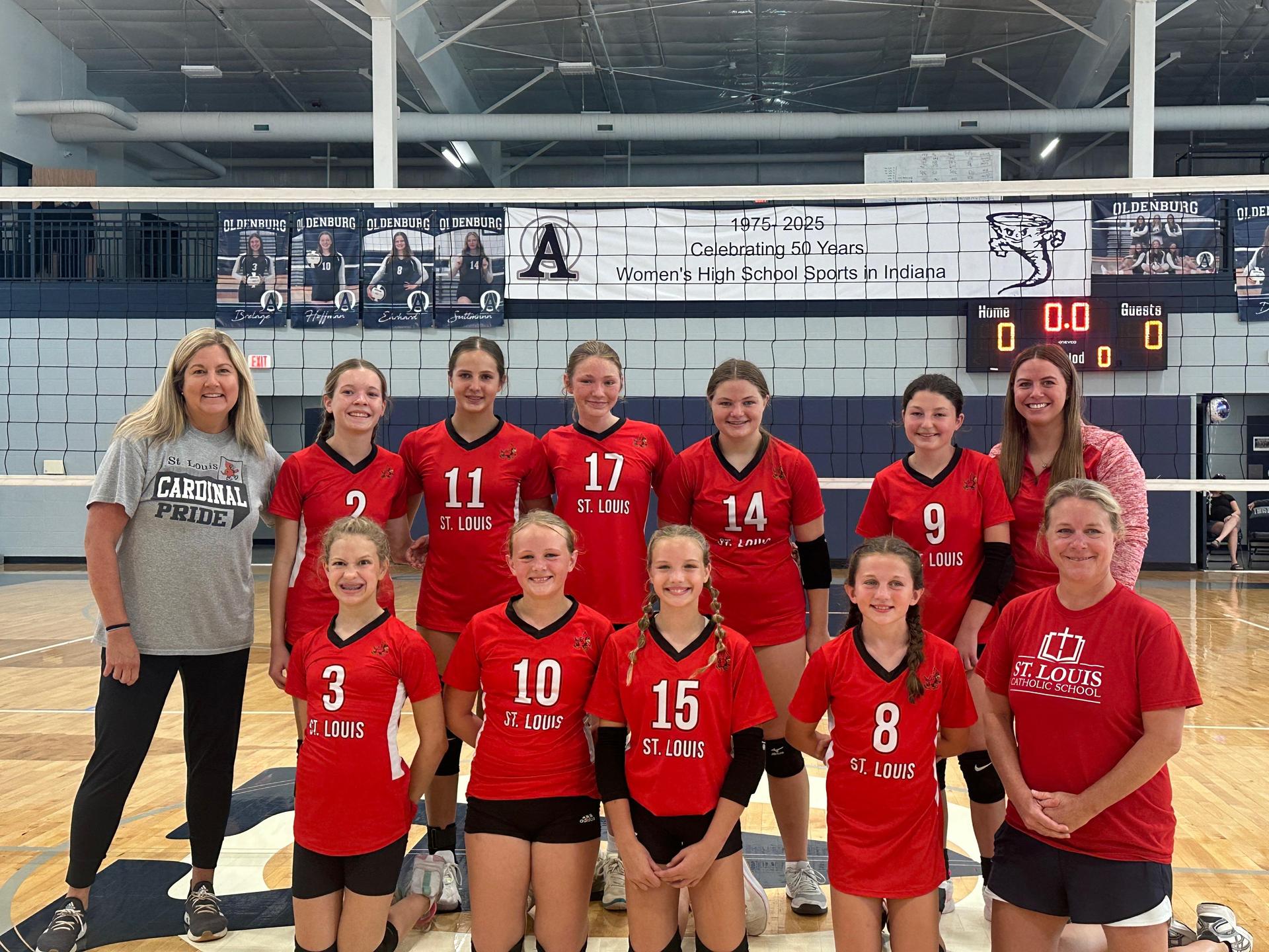 St. Louis 8th grade volleyball team posing together after tournament.