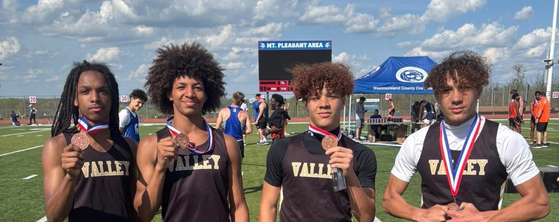 Valley Track Athletes holding their medals