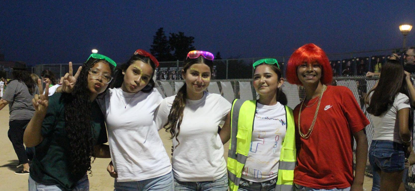 Group of friends in playful outfits with accessories at an event.