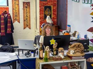teacher sitting at her desk