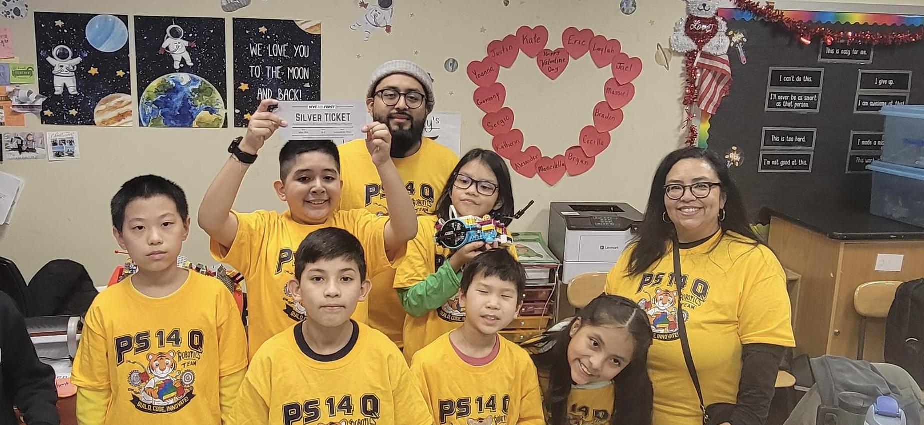 Robotic team wearing yellow blue letter tshirt with lego robots