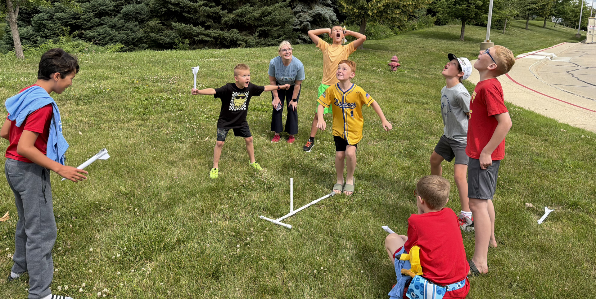 A group of children playing a game outdoors, with excitement and laughter.