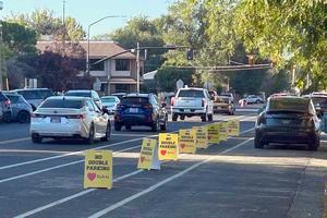 Cars inline to drop off students. No double parking signs are on street.