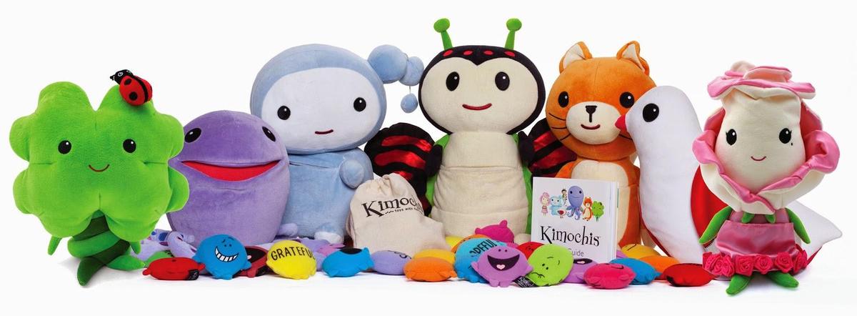 Kimochi plushies sitting together with a book