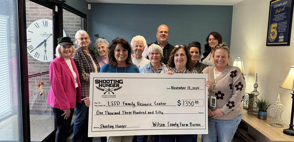 Large Check presented to a group of older adults