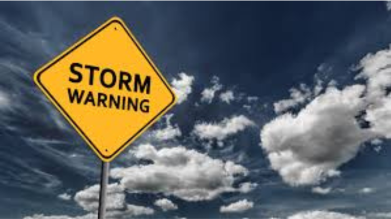 storm warning sign with stormy sky