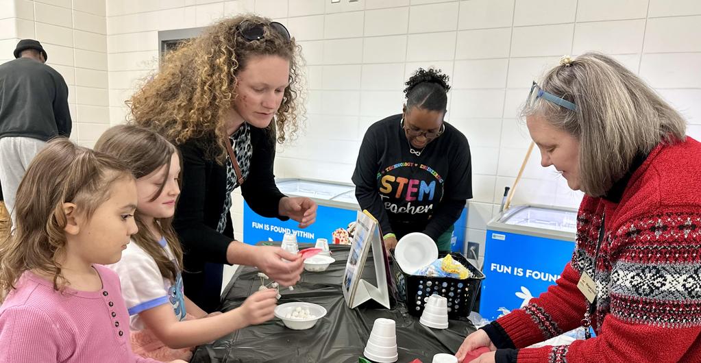 Teachers helping parent and students with project