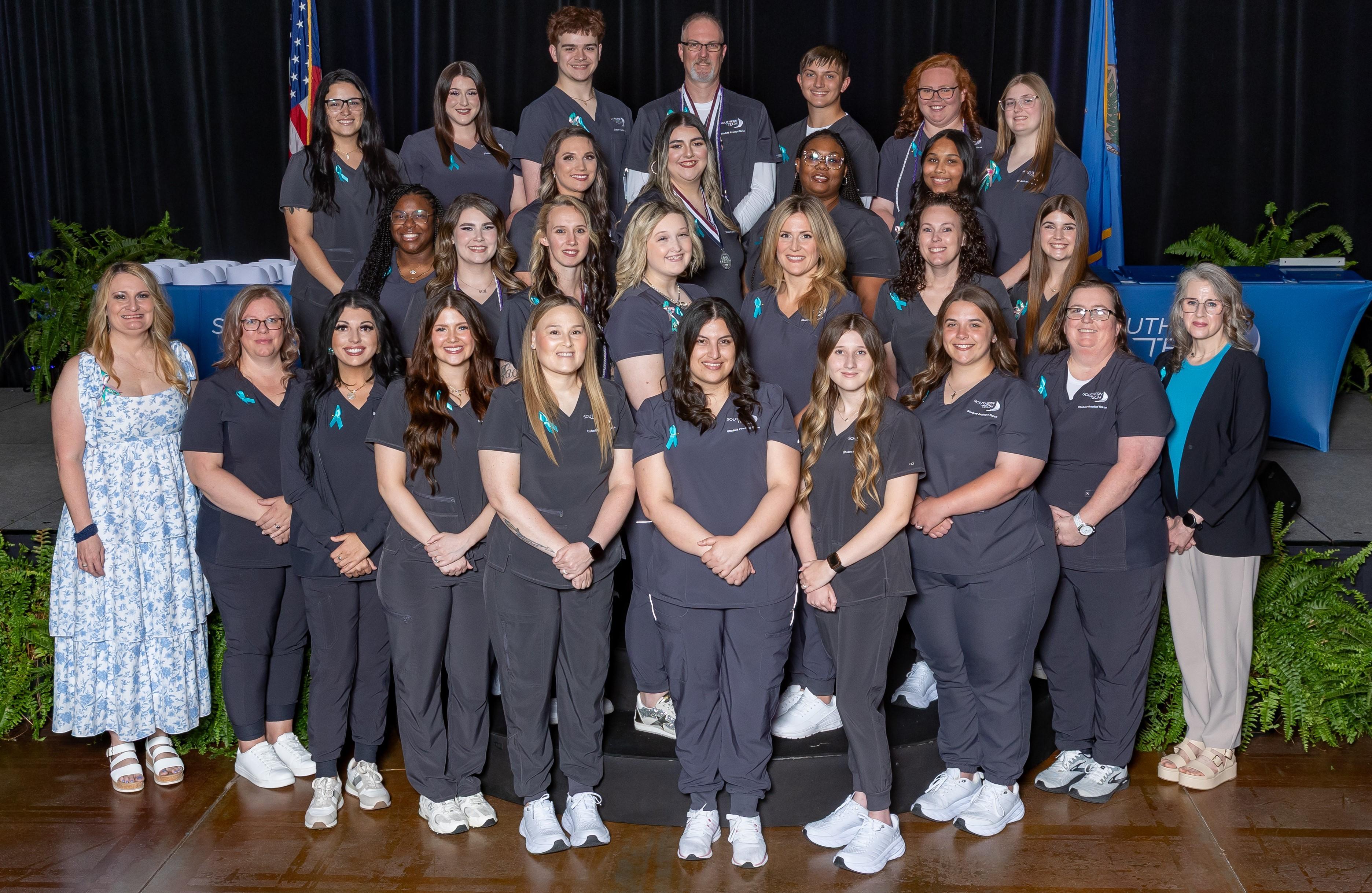 group of diverse nursing students and teacher at completion ceremony 2025