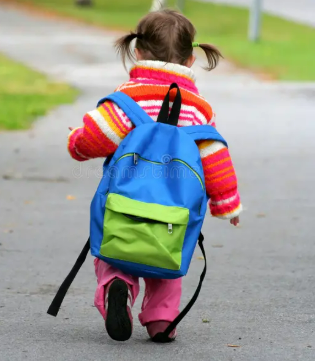 small child wearing backpack with straps dangling on ground