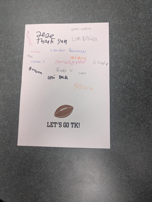 A card of thanks to be sent to donors includes football player signatures.