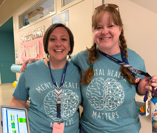 Two teachers wearing matching Mental Health Matters t-shirts