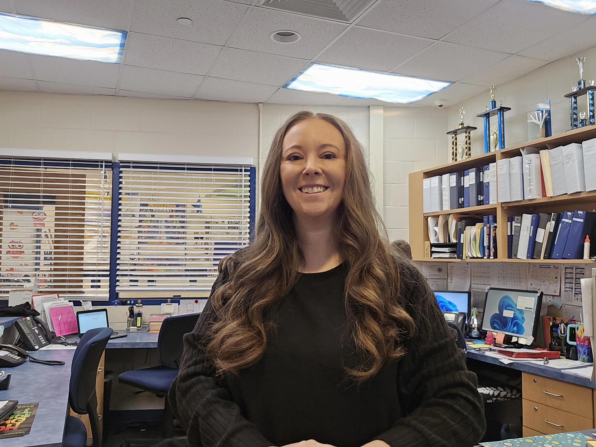 Woman with long hair at office counter